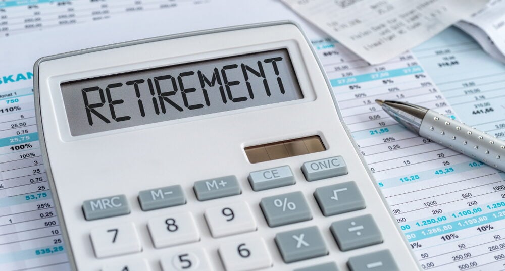A white calculator with the word "RETIREMENT" displayed on its screen